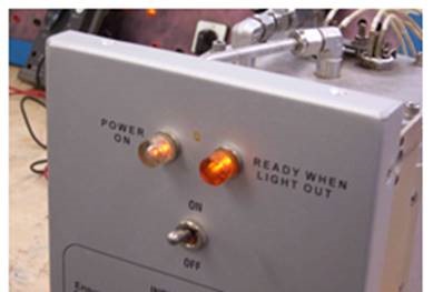 Hot water dispenser with neon indicators.